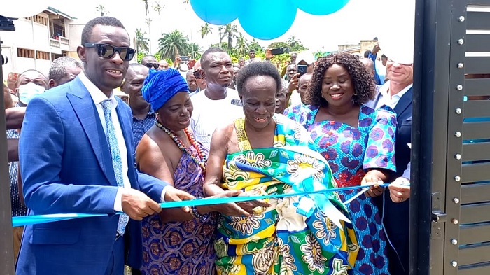 The Western Regional Minster, Mr Kwabena Okyere Darko-Mensah, left, being assisted by Paramount Chief of the Western Nzema Traditional Area, Awulae Annor Adjaye, second right, and the MCE for Jomoro, Louisa Iris Arde, to commission the 570-capacity block.(Tull2 inset)