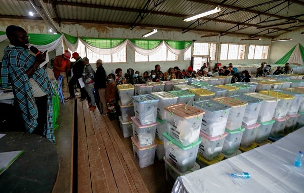 • A general view shows polling agents and sealed ballot boxes containing electoral materials at an Independent Electoral and Boundaries Commission (IEBC) tallying centre