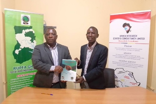 Mr. Ashaley (left) and Prof. Teitey shaking hands after signing the MoU