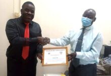 Mr Matthew Ayoo (right) receiving the Certificate of Appreciation from Mr Nicholas Amarteyfio