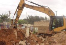 • Excavator demolishing some of the structures