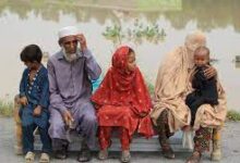 • Displaced people wait for relief at a flooded area in the Charsadda District, Khyber Pakhtunkhwa province