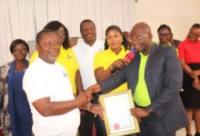 Mr Kwabena Yeboah Apraku (right),presenting the certificate of operation to Pastor. Dr Kwame Annor Boahen(left). With them are staff of AHCoF limited. Photo. Ebo Gorman