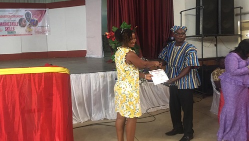 Emefa Doe, (left), a participant receiving a certificate from Rev. Stephen Ebo Kesse, Western Regional Director of CNC