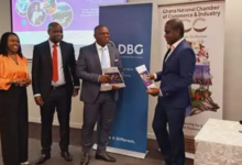 Mr Amoako (second right) receiving a document from DBG Official