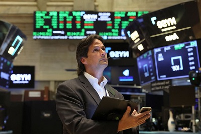 • A trader works on the floor of New York Stock Exchange in New York City. Source: Reuters