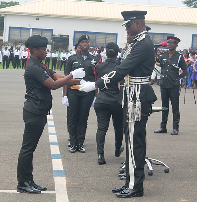 • COP Paul Manly Awini(right) presenting the overal best recruit award to Gifty Boahemaa Kwapong . Photo: Godwin Ofosu-Acheampong