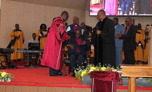 Rev Enoch Nii Narh Thompson (seated) being inducted into office by the clergymen Photo Ebo Gorman