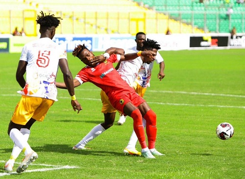 Kotoko's Steven Mukwala comes under a challenge from a Hearts player while Konadu Yiadom (left) and Eric Esso close in