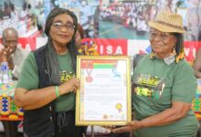 Madam Ethel Jacks, Ghana's table tennis queen (right) picks her award from the WISA President