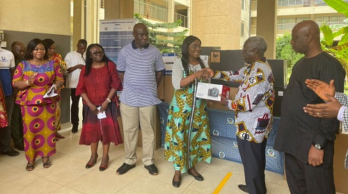 Mr Osafo Maafo presenting the equipment to Dr Fofie, a representative of one of beneficiary institutions