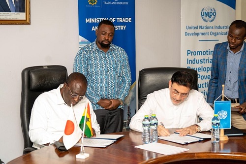 • Mr Kyerematen (left) and Mr Azizi signing the pact