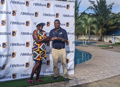 Ms Akoto receiving her prize from an official of FBN