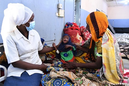 A seven months old baby being examined in a UNICEF-funded clinic to find extent of malnutrition