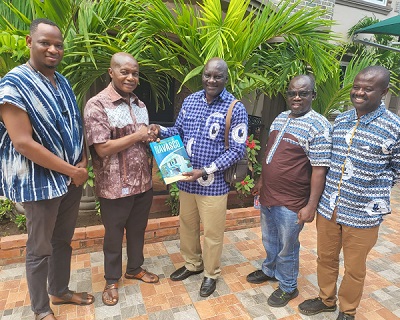 Mr Alabira (middle) presents the book to Mr Ntim (second from left), looking on are Awinzo ( left), Avoka (second right) and Abdul-Rahaman (right.)