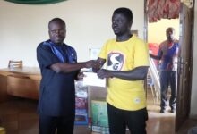 Mr Kwarteng (left) presenting a cash donation to a beneficiary at the event