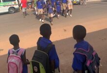 Nervous children crossing the road after school