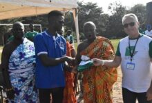 Mr Andrews Gyawu receiving a cheque from Mr Barre (right)