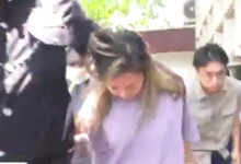 • Aisha Huang being escorted out of court
