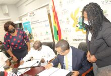 Mr Ken Ofori-Atta (second from left) and Mr Sam Aidoo,Exec. Director,Wholesale Banking,GCB signing the agreement