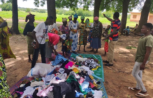 Mr Nchor and the beneficiaries inspecting the items