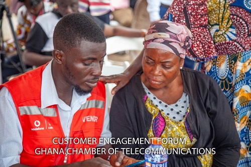 A Vodafone official educating a customer
