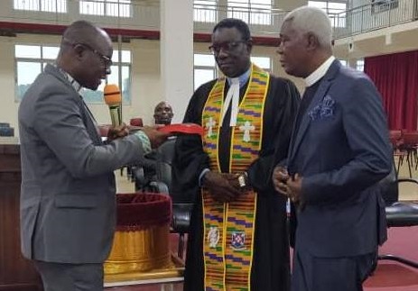 Rev Dr Aryee-Atta, handing over the new revised Bible to Rev Christian Amankwah Kwafo and Rev Charles B Ahwireng, Retired Presbyterian Minister.