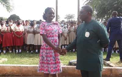 Mr. Okyere interacting with one of the exams staff, while the candidates looked on