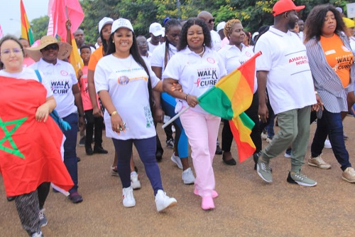 Dr Wiafe-Addai holding Ghana flag with other participants during the walk