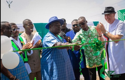 (Inset) Opanyin Kwame Wadie , ( Father of Nana Owiredu Wadie I) cutting the tape to inaugurate the plant as other dignitaries look on.