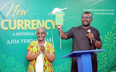 Inset, Mr. Kofi Owusu (right) launching the book. With him is Ms. Ajoa Yeboah-Afari
