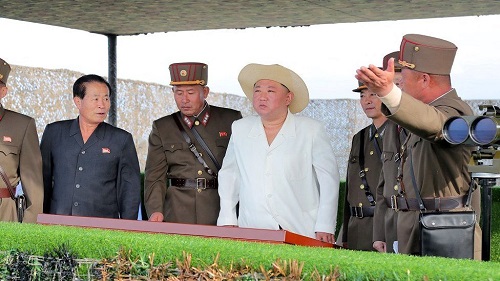 Kim Jong-un (middle) presiding over the missile launches
