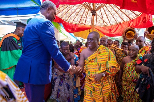 Osagyefo Oseadeeyo Dr Agyemang Badu II exchanging greetings with Dr Adutwum (left)