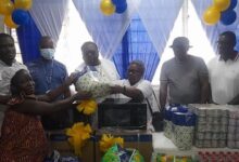 Ms Yaa Boatemaa presenting gift to one of the mothers at the maternity ward
