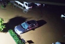 Cars and vehicles submerged in the rain at ECG office