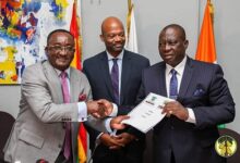 Dr Akoto (left) presenting the charter to Ivorian Minister of Agriculture and Rural Development,KobenaKouassiAdjoumani. Looking on is Alex Pierre-ArnauldAssanvo, the Executive secretary of the CIGCI