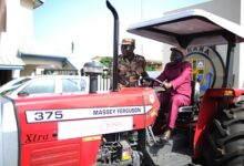 Mr. Kwame Osei-Prempeh (right) assisted by Mr. Isaac Egyir to test the tractor after the presentation. Photo Geoffrey Buta
