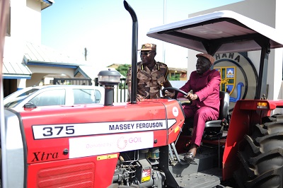 Mr. Kwame Osei-Prempeh (right) assisted by Mr. Isaac Egyir to test the tractor after the presentation. Photo Geoffrey Buta