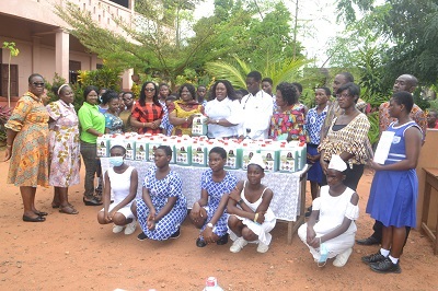 Ms Sowah (fifth from right) presenting the liquid soaps to Ms Kutomah (sixth from left) during the programme Photo Victor A. buxton
