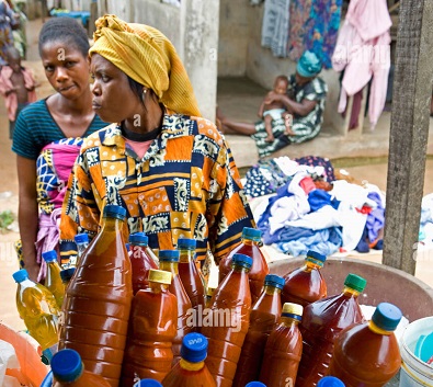 A woman selling palm oil.
