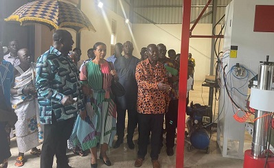 Alan Kyerematen (left) being briefed on the operations at the factory