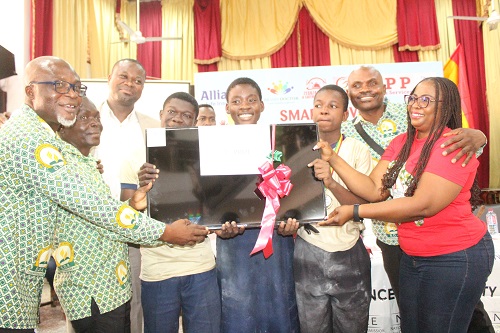 Mrs Lucille Hewlett Annan (right) Director, NCCE presenting the overall best award to the team of SDA preparatory, Bubuashie Accra Photo. Ebo Gorman