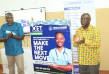 Prof. Obeng Mireku (right) and Mr Ebenezer Amuasi applauding after launching the OET programme. Photo. Ebo Gorman