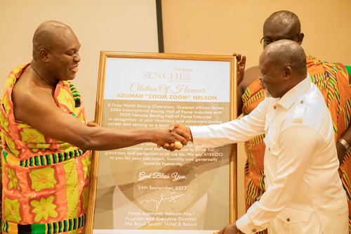Odeneho Akoto III (left) presenting Azuma Nelson with a citation at the event