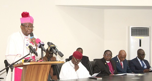 Most Rev. Philip Naameh (standing) addressing the press conference. With him are some leaders of the Clergy. Photo. Ebo Gorman.
