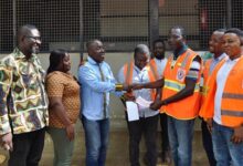 Mr Daniel Boye (third from left) presenting the cheque to Mr Emmanuel Adu-Boahen and his NADMO team