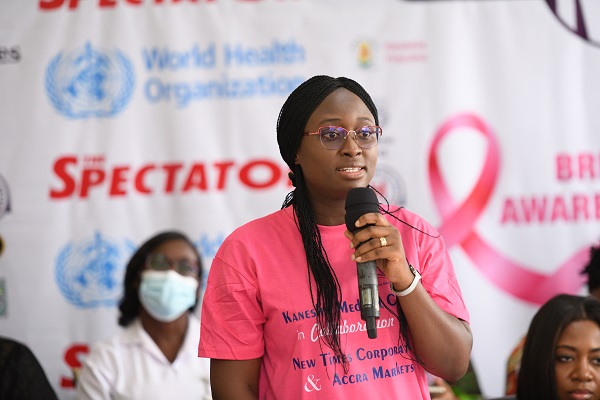 An official giving a talk on breast to the market women during exercise