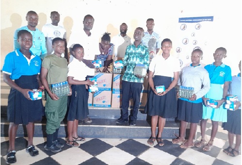 Officials of Amplify Change and students of Bechem School of the deaf showing the items presented