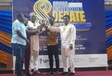 Dr Bello Bitugu (middle) supported by other different to present the winning trophy to team KNUST