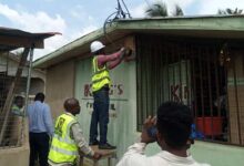 An ECG official removing a fake meter
